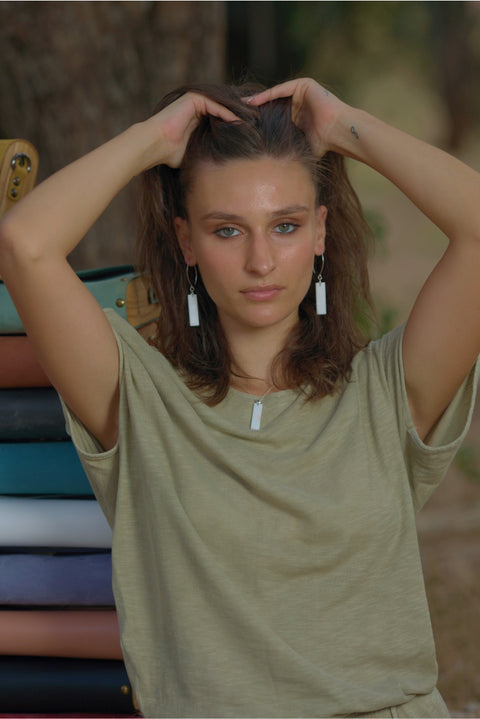 Women wears pure white Thassos marble earrings