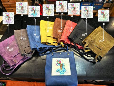 Collection of colorful bags with embroidered designs on a table.
