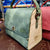 Green oil leather top handle bag and olive treee wood