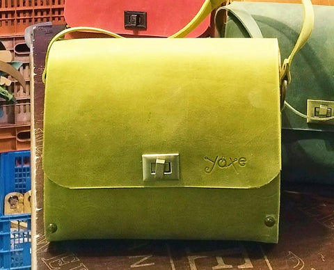 Yellow oil leather top handle bag and olive treee wood
